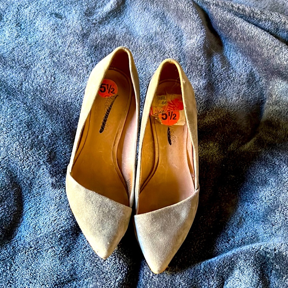 Once worn, grey stilettos.